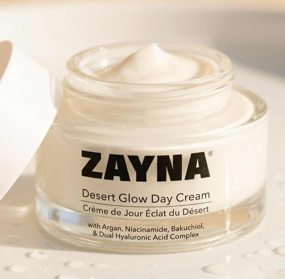 ZAYNA Desert Glow Day Cream in an open glass jar with a creamy white texture, featuring argan oil and niacinamide.