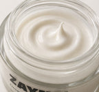ZAYNA Desert Glow Day Cream with a smooth, creamy white texture inside a glass jar for skin hydration.
