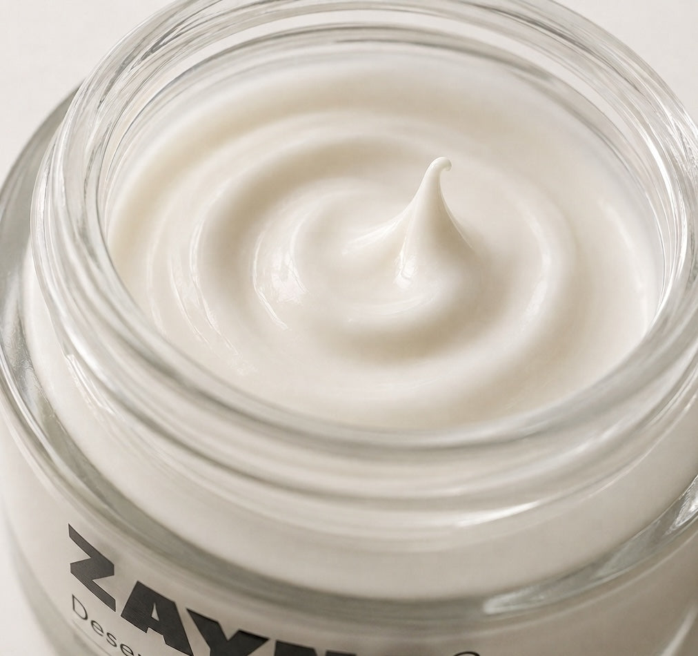 ZAYNA Desert Glow Day Cream with a smooth, creamy white texture inside a glass jar for skin hydration.